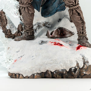 A low-angle shot of Connor's boots on the statue, showing them on the snowy base next to the discarded hat and blood stains.