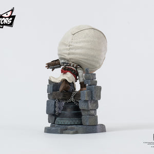 Back-right angle of the PureArts Qlectors Altaïr figure, displaying the sculpted detail of his hood and the textures of the stone bell tower structure.