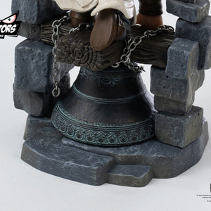 A detailed close-up of the base of the PureArts Qlectors figure, focusing on the ornate design of the bell and the texture of the stone bricks.