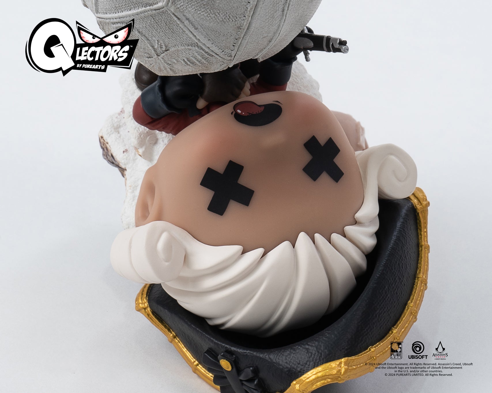 A detailed close-up of the fallen British soldier's head from the PureArts Qlectors figure, showing the detail of his white hair, black hat, and stylized "x" eyes.