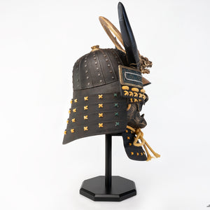 Left side view of the full PureArts Yasuke helmet replica displayed on its stand, showing the detailed side profile and the impressive scale.
