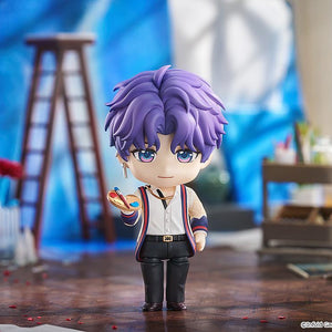 Rafayel Nendoroid figure displayed in an art studio diorama holding a paint palette and brush surrounded by studio props.