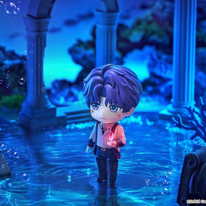 Rafayel Nendoroid figure standing in a submerged blue ruins diorama with a small glowing pink flame effect in his hand.