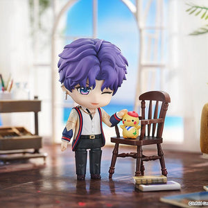 Winking Rafayel Nendoroid figure posing in a sunny room diorama beside a chair holding the Artsy Birb figure.