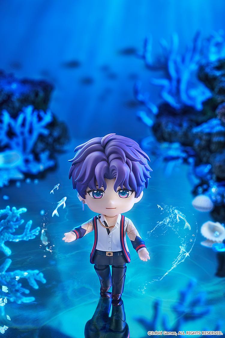 Rafayel Nendoroid figure extending his hand in a bright blue underwater coral scene surrounded by glowing magical swimming fish.