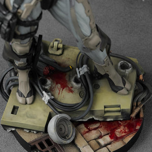 Detailed view of the statue's base showing bullet impacts, severed cables, and weathered stone textures.