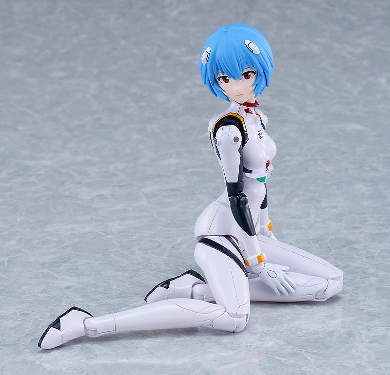 Seated floor pose of the PLAMATEA Rei Ayanami model kit demonstrating flexible leg articulation.