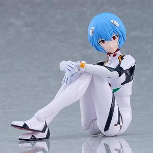 PLAMATEA Rei Ayanami action model figure in a seated pose hugging her knees on a gray studio surface.