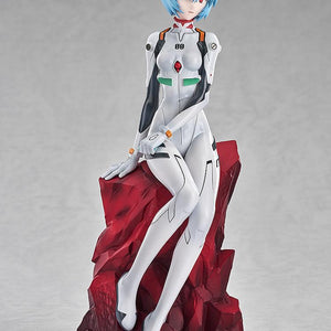 Studio shot of the Rei Ayanami figure showing her graceful seated pose and short blue hair against a grey background.