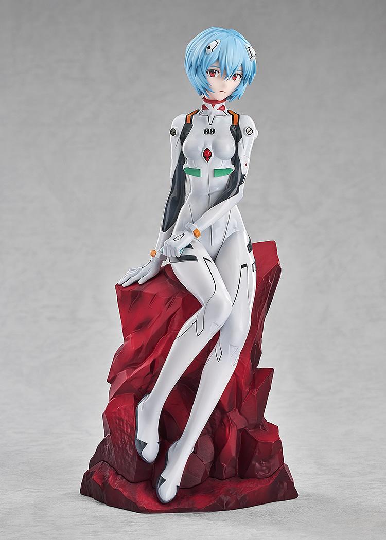 Studio shot of the Rei Ayanami figure showing her graceful seated pose and short blue hair against a grey background.