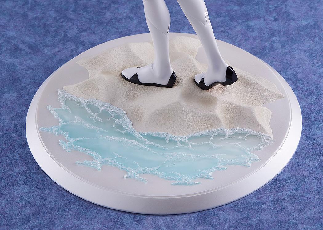 Detailed shot of the figure's base, featuring realistic sand textures and translucent blue water with white sea foam effects.