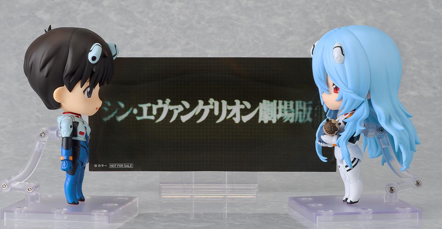 Rei Ayanami and Shinji Ikari Nendoroids displayed with the included Rebuild of Evangelion title background sheet.