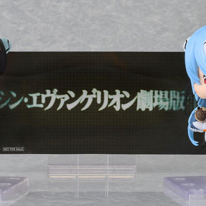 Rei Ayanami and Shinji Ikari Nendoroids displayed with the included Rebuild of Evangelion title background sheet.
