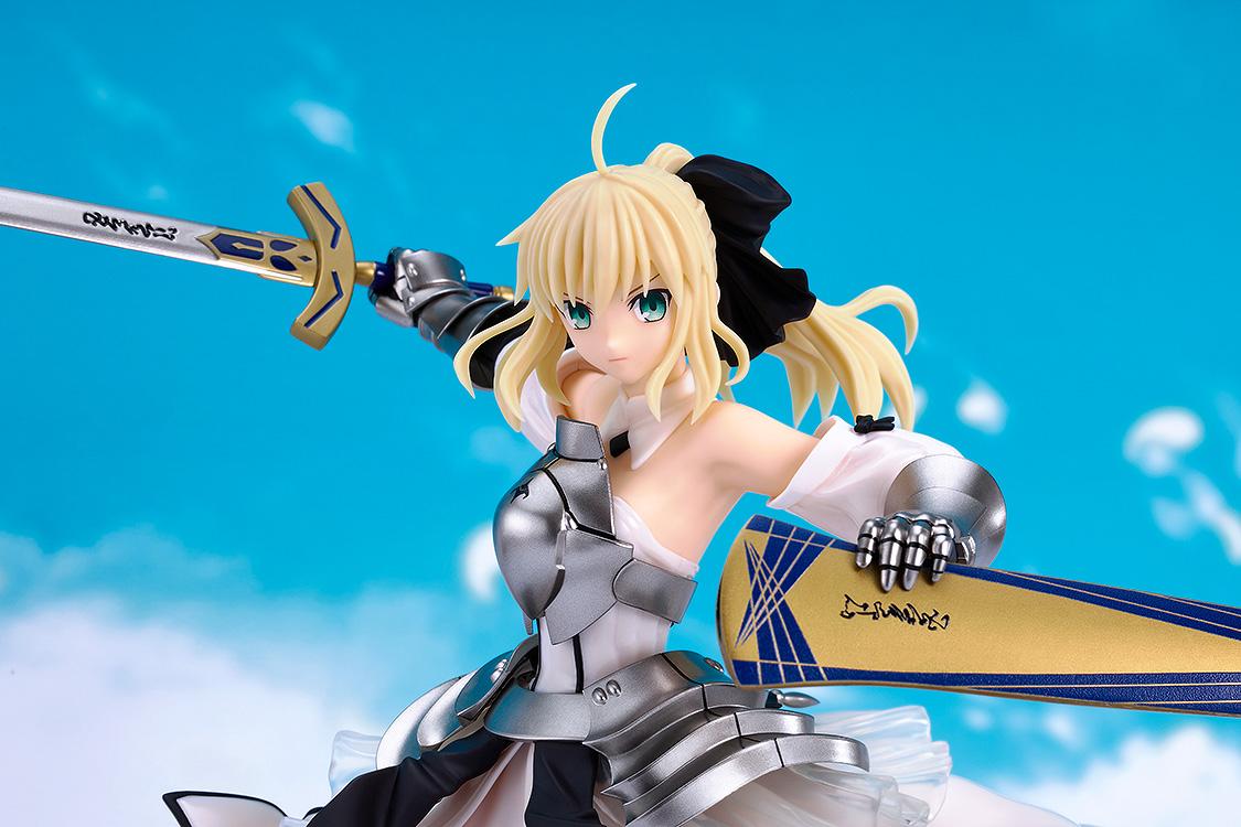 Close-up of the fully painted Saber Lily plastic model kit showcasing her detailed face sculpt and armor against a sky background.