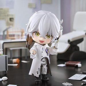 Wide diorama shot of the Medicine Pocket Nendoroid figure reaching a hand out with a wide laugh, surrounded by miniature lab equipment and medical clutter.