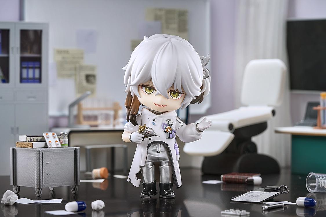 Medicine Pocket Nendoroid holding the Migur 0-1 device in a medical research lab setting next to a miniature steel utility cart.