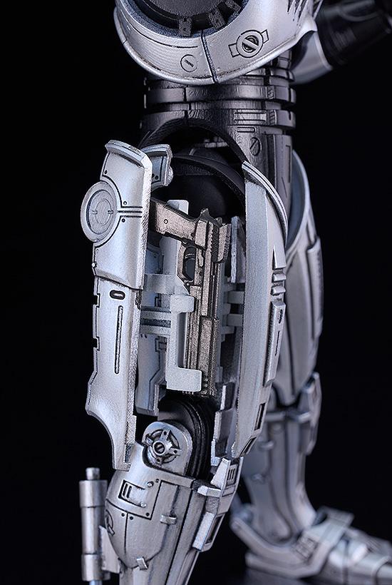 Close-up of the right thigh assembly showing the functional holster parts and ejected Auto 9 state.