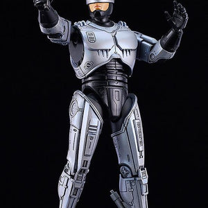 Articulated RoboCop model kit in a dynamic firing pose with the Auto 9 weapon raised and hand extended.