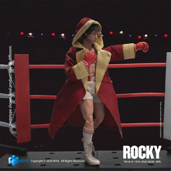 Hiya Toys Exquisite Super Series 1/12 scale Rocky Balboa action figure wearing a red hooded entrance robe in a boxing ring pose.