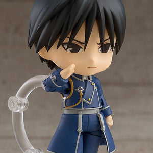 Profile view of the Roy Mustang Nendoroid figure in a serious saluting pose, highlighting the detailed Amestris military uniform and articulated arms.