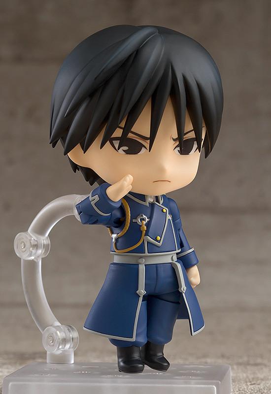 Profile view of the Roy Mustang Nendoroid figure in a serious saluting pose, highlighting the detailed Amestris military uniform and articulated arms.