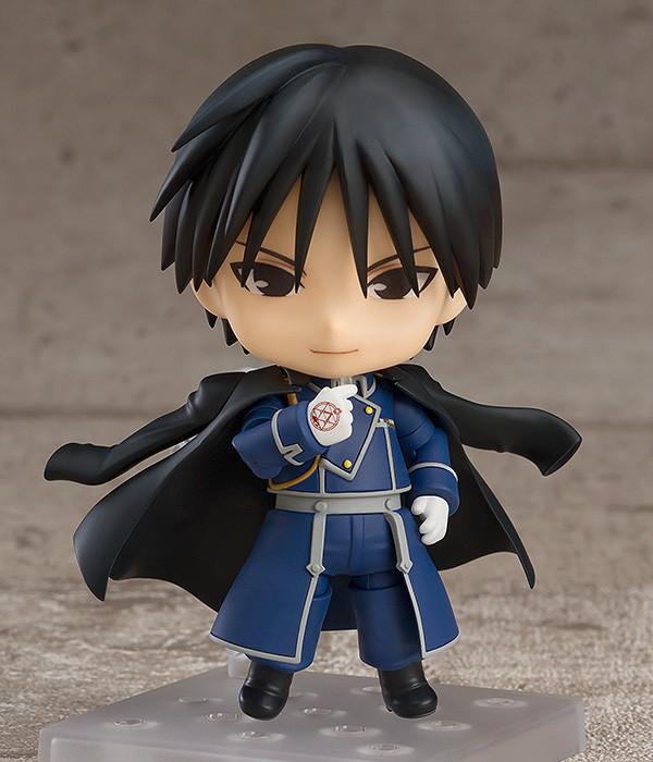 Roy Mustang Nendoroid standing on a display base with a fearless standard smiling face plate and his black coat draped over his shoulders.