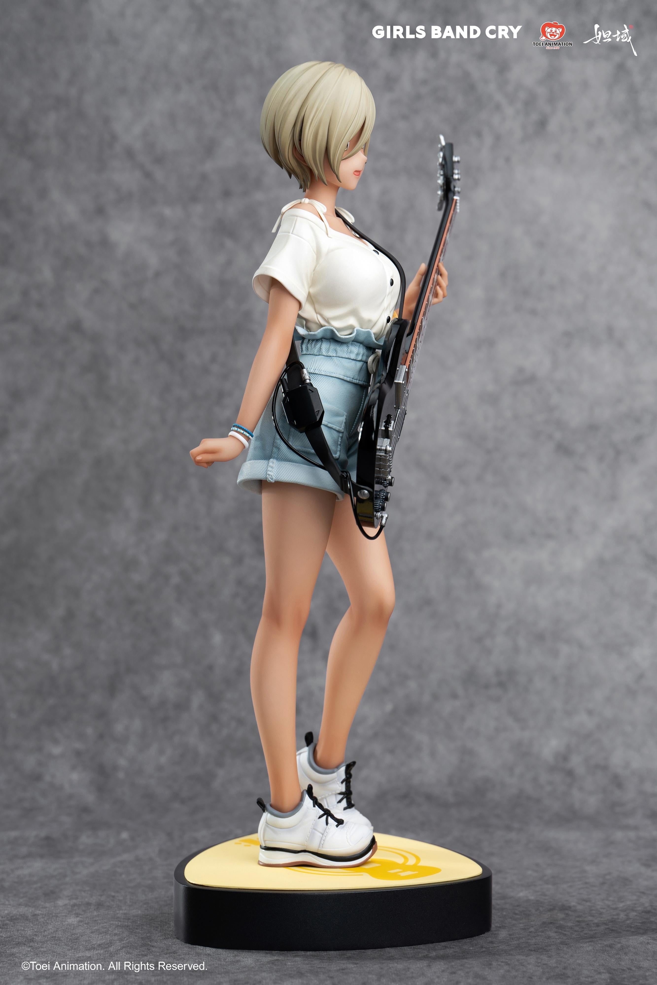 Side profile of the Rupa scale figure showing the detailed white shirt, denim shorts, and guitar strap.
