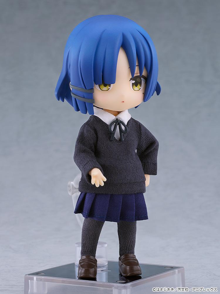 Three-quarter view of the Ryo Yamada Nendoroid Doll anime figure showcasing the high articulation and fabric detailing of her knit school uniform sweater and navy pleated skirt.