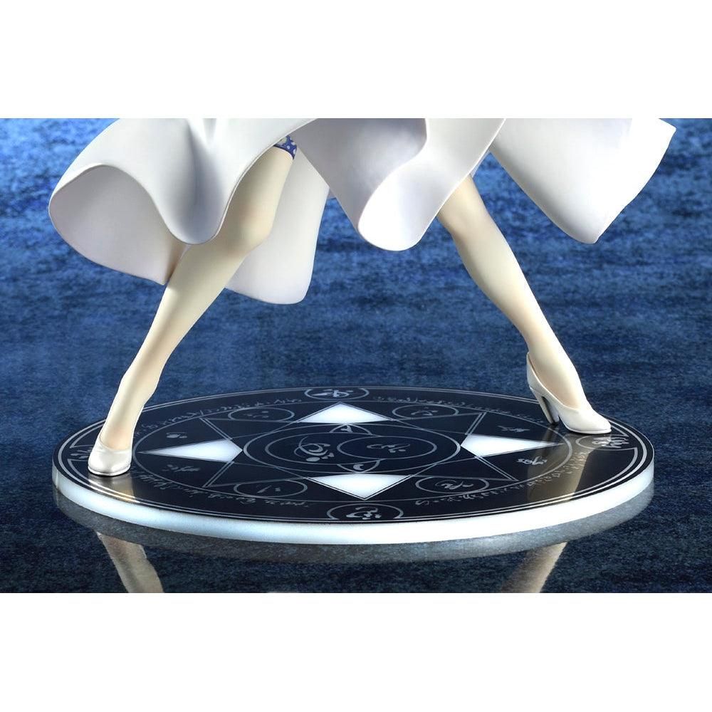 A detailed close-up of the base of the Saber/Altria Pendragon figure, showing her feet in white heels and the intricate magical spell circle on the stand.
