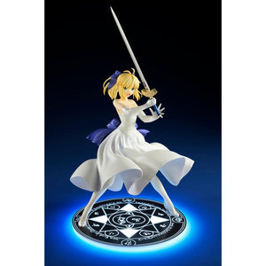 Front view of the Saber/Altria Pendragon figure, with a lit-up base showing a glowing blue magical effect on the spell circle.