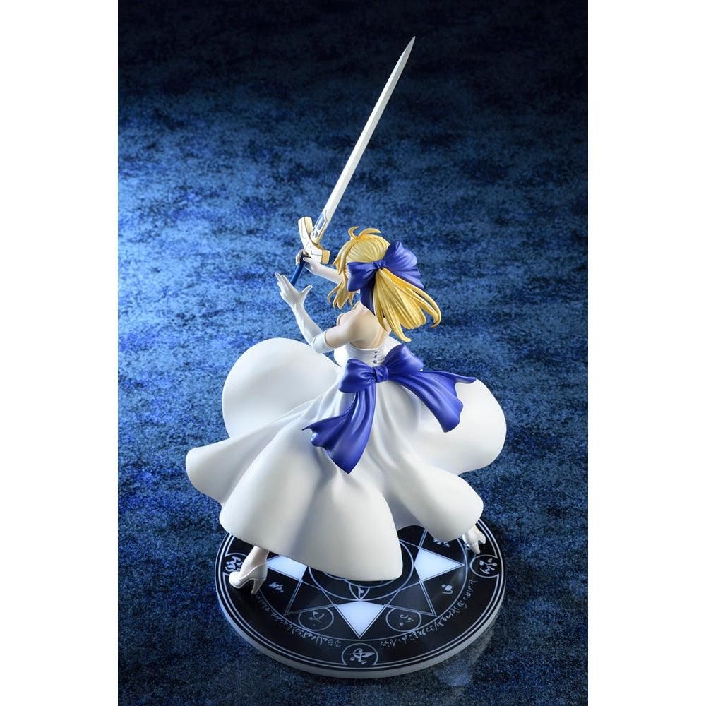 A three-quarter view of the Saber/Altria Pendragon figure from the left, highlighting her flowing dress, Excalibur, and the magical symbol on the base.
