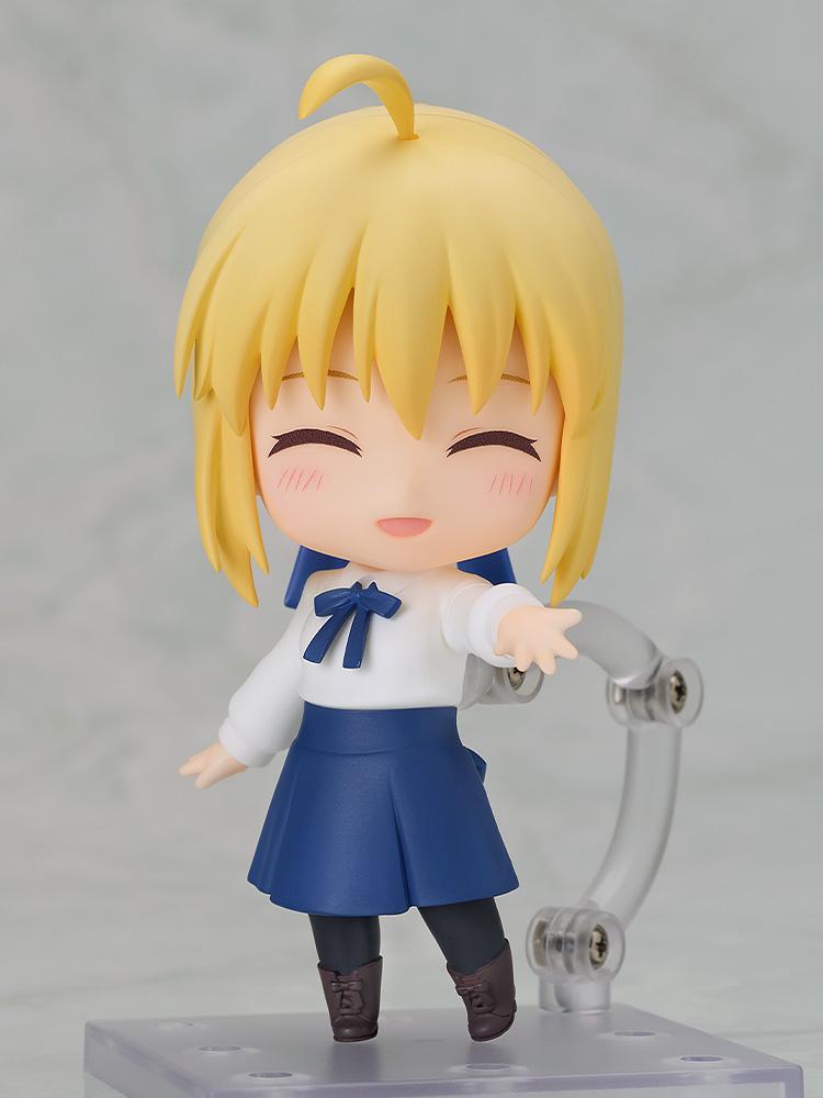 Saber Casual Outfit Version Nendoroid figure reaching out with a joyful, closed-eye cheerful face plate expression on a clear display base.