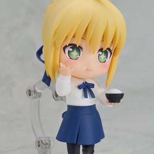 Standing Saber Casual Version Nendoroid figure holding a bowl of white rice with blushing cheeks and a delighted sparkling expression.