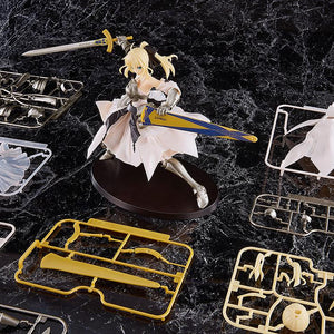 The assembled Saber Lily model kit displayed alongside its unassembled plastic runners and parts included in the box.