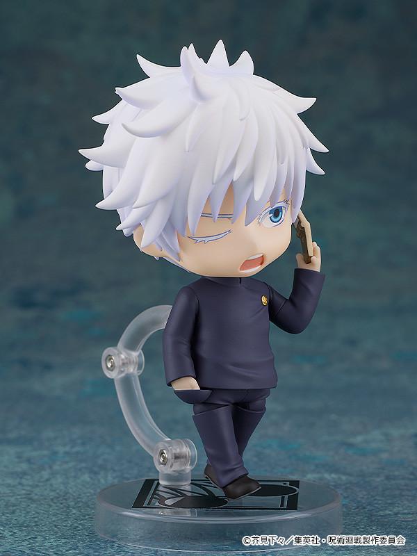 Satoru Gojo Nendoroid figure showing a comical aggravated winking face plate while holding a flip cell phone accessory up to his ear.
