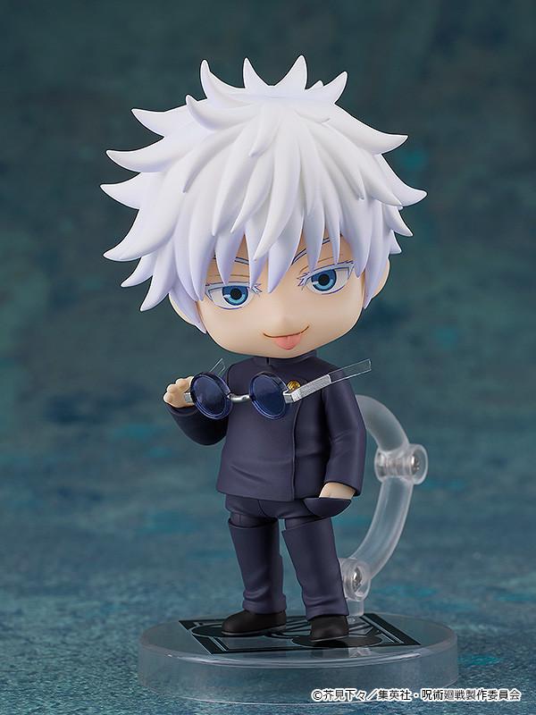 Satoru Gojo Nendoroid figure revealing his bright blue eyes as he lowers his dark round sunglasses with a smug, teasing expression.