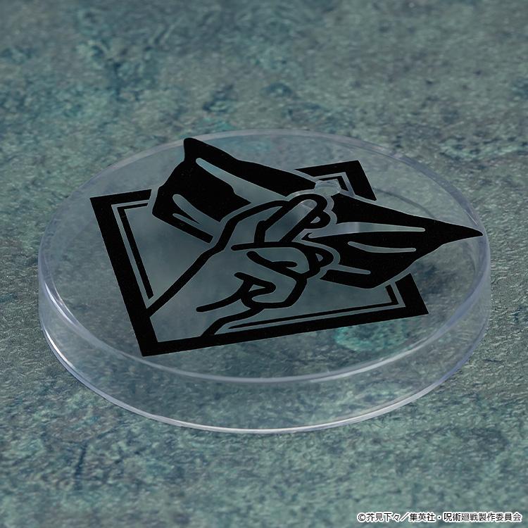 Top-down view of a clear circular Nendoroid display stand base featuring a black graphic print of Satoru Gojo's eye mask hand sign.