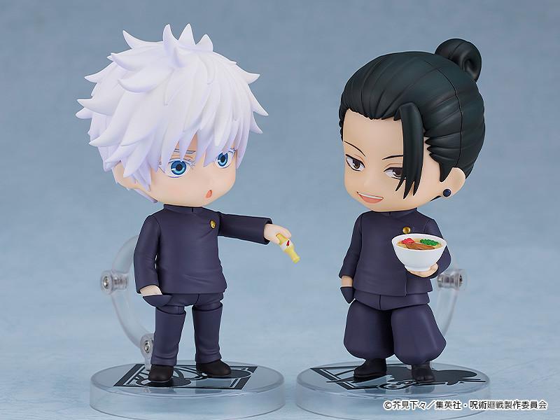 Satoru Gojo Nendoroid offering a Koregusu bottle to a smiling Suguru Geto Nendoroid holding a miniature bowl of ramen, recreating a slice-of-life anime scene.