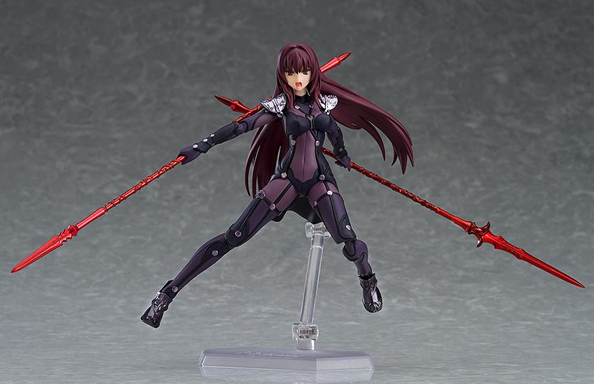 Dynamic mid-air leaping action pose of the Scathach figma figure featuring her shouting face plate while dual-wielding two red magic lances.