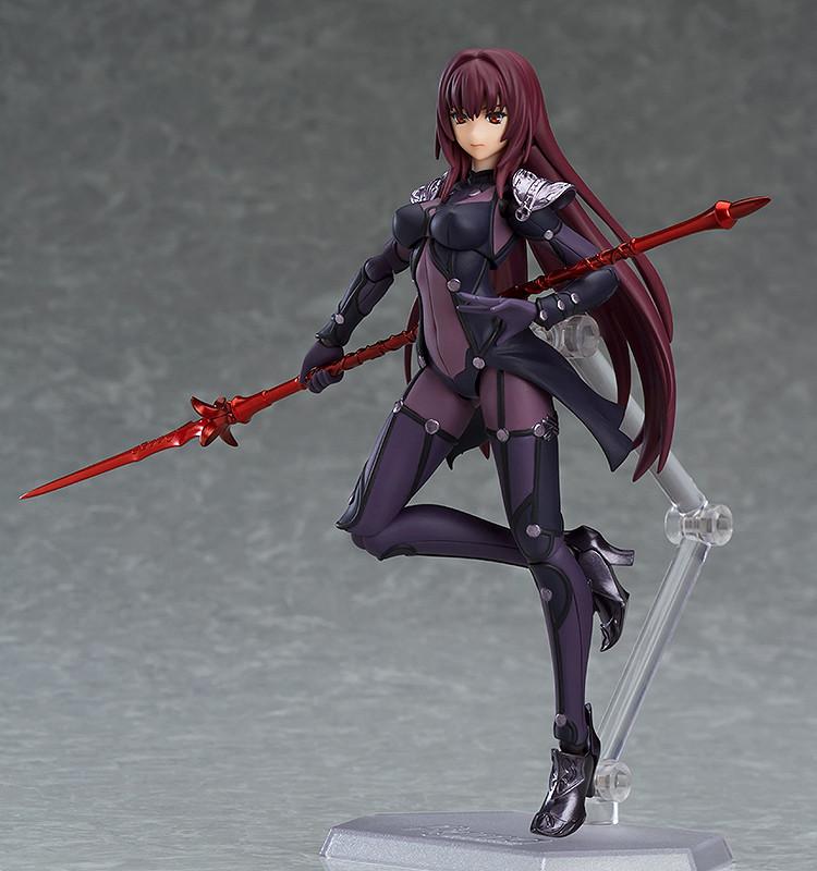 Three-quarter view of the Scathach figma action figure highlighting her fearless smile face plate while holding a crimson magic lance behind her back.