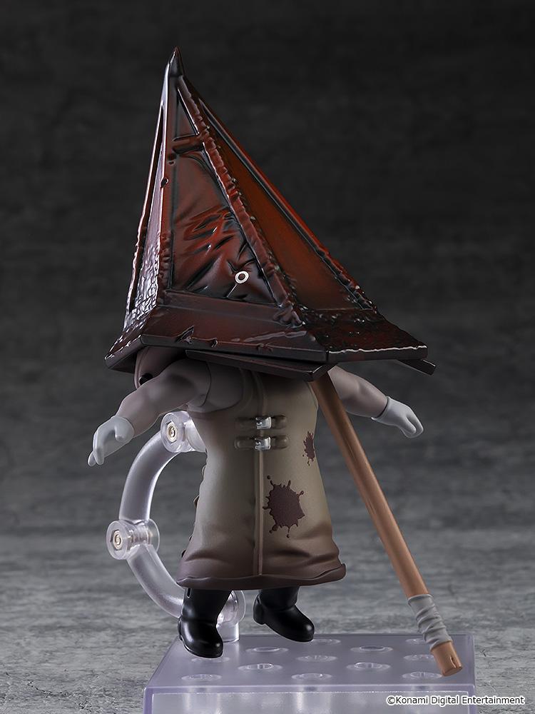 Rear studio view of the Red Pyramid Thing Nendoroid figure showing the back of the blood-stained coat and metallic pyramid helmet.
