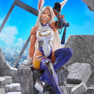 Full-body promotional image of Mirko posed on a rock base in a battle-damaged urban environment.