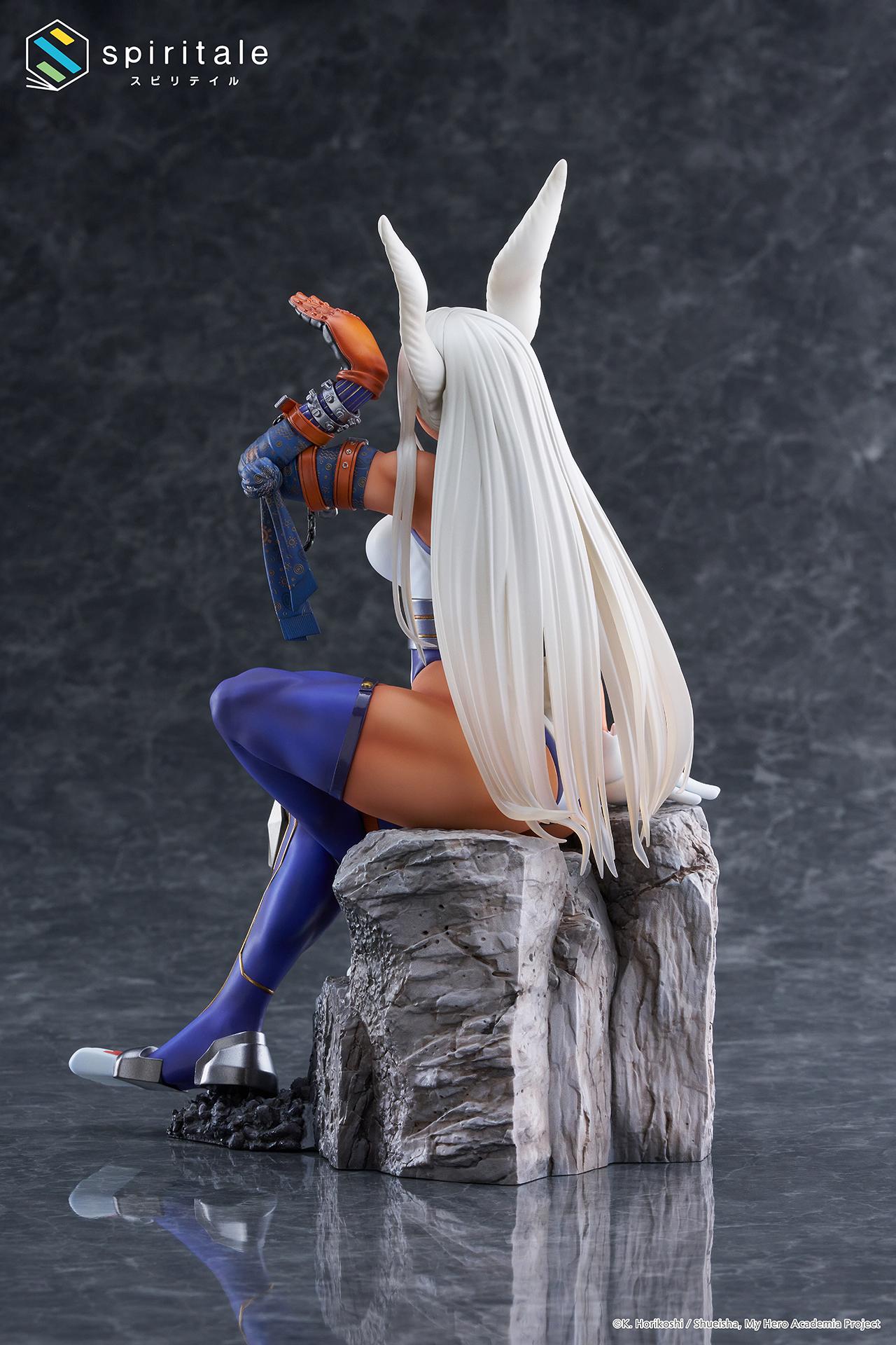 Rear studio shot showing Mirko's flowing white hair, rabbit tail, and the texture of the rock base.