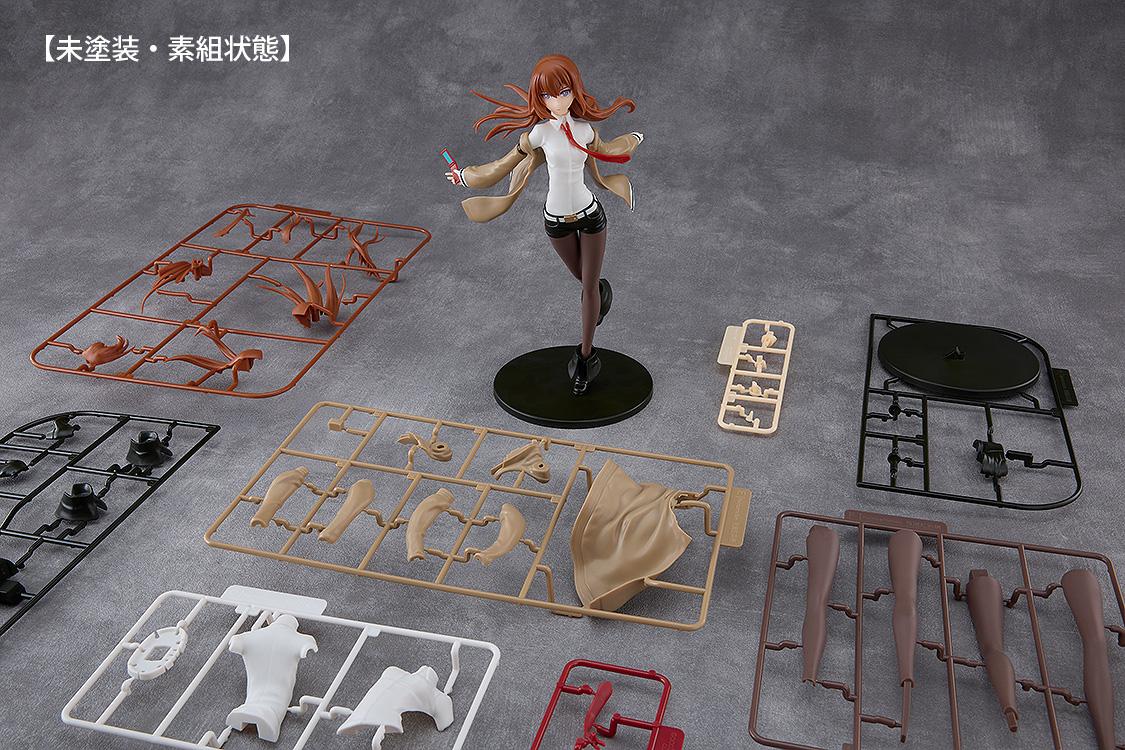 Unassembled plastic sprues and colored runners laid out beside the assembled Kurisu Makise model kit.