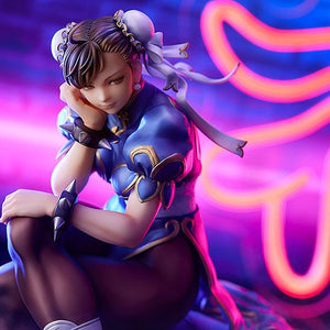 Close-up promotional image of Chun-Li statue with atmospheric neon light and smoke effects.