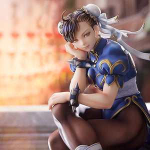 Close-up landscape view of Chun-Li's face and upper body in a blurred urban daylight environment.