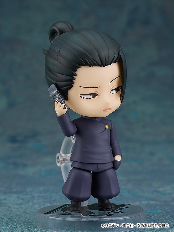 Suguru Geto Nendoroid figure looking downward with a serious expression while holding a miniature flip cell phone accessory to his ear.