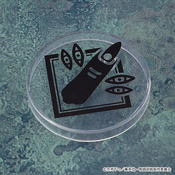 Top-down view of a clear circular Nendoroid display stand base featuring a black graphic print of Ryomen Sukuna's cursed finger and eyes.
