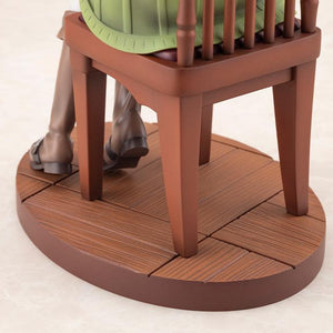 Close-up view of the sculpted wood-grain circular display base and wooden chair legs.