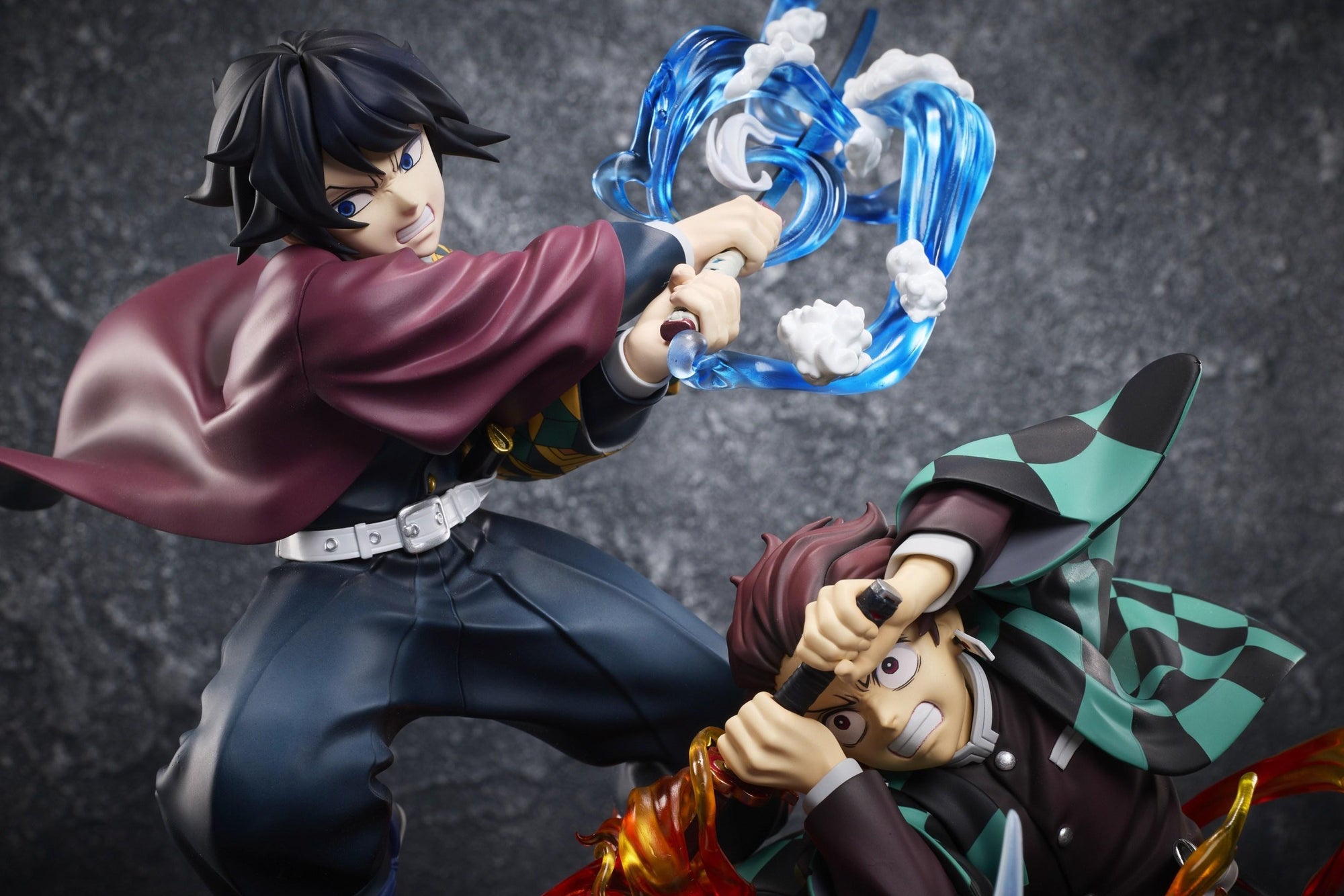 Focus on Giyu Tomioka and Tanjiro Kamado fighting side by side with water and fire effects in the Aniplex battle figure